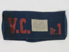 An unknown WWI arm band, in frame.