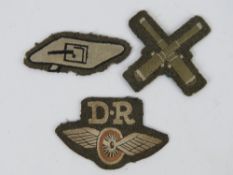 Three assorted WWII British cloth badges, in frames.