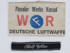 A WWII German Airforce Workers arm band together with a Hitler cuff title, in frame.