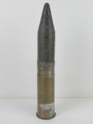 An inert WWII German 7.5cm Kwk Armour Piercing shell, dated 1942 with German marks upon.