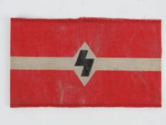 A WWII German Hitler youth arm band, in frame.