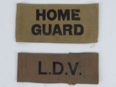 A WWII Home Guard arm band together with a WWII LDV arm band, in frames.