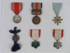 Six WWII Japanese medals and ribbons, in frame.