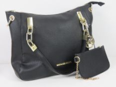 A black Michael Kors handbag having purse within, lining a/f near pocket 34 x 26cm.