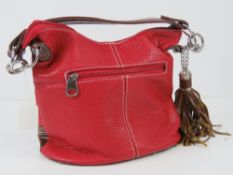 A red and brown Paula Rossi handbag with key chain tassel 25 x 22cm.