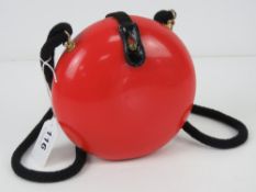 A c1960s Italian pop art style purse in red, marked for Diva, 15cm diameter.