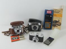 Three vintage cameras including Kodac Retinette, Halina and Mastra V35.