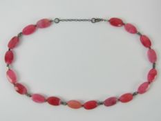 An 'as new' hot pink hardstone necklace having 925 silver clasp, in box.