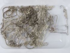 Twenty assorted silver chains.