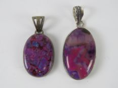 Two purple hardstone pendants in white metal settings, each stamped 925, 4.3cm and 5.