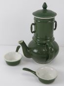 An unusual green and white ceramic hot chocolate pot including filter and two drinking saucers,