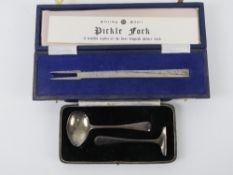 A HM silver pickle fork - a replica of the 'Manners' fork, the oldest English silver table fork,