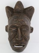 An African carved wooden wall mask, 36cm high.