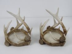A pair of 'antler' wine bottle coasters or candle stands, each approx 17cm wide, 15cm high.
