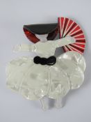 An overlaid plastic brooch in the style of Lea Stein in the form of a lady with fan and hat,