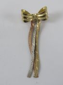 A 9ct gold brooch in the form of a bow, hallmarked 375, 4cm in length, 1.4g.