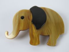An overlaid plastic brooch in the style of Lea Stein in the form of an elephant, 7cm wide.