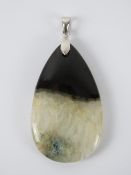 A large hardstone pendant in black and white, bale stamped 925, total length 6cm.