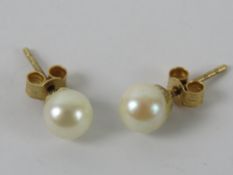 A pair of 9ct gold and pearl stud earrings.