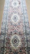 A silk pink and blue ground runner having geometric design, 372 x 96cm.