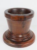 A fine quality turned fruitwood stepped planter with lead insert. Planted 22cm dia, base 27cm.