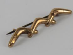 An Australian 9ct rose gold brooch in the form of three boomerangs, slightly a/f, 1g.
