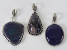 Three purple hardstone pendants, each stamped 925, one being Blue John,