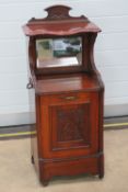 An Edwardian mahogany perdonium fireside coal scuttle with bevelled edge mirror over,