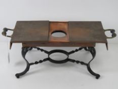 A copper and cast iron warming stand.