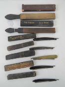 A quantity of late 19th / early 20th century shaving strops and razors inc the 'seal skin' strop,