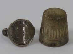 An HM silver thimble, hallmarked for Birmingham, together with a three pence coin ring. Two items.