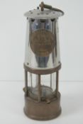 A 'miners lamp' made by the Protector Lamp & Lighting Company Ltd Eccles',