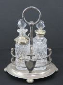 A silver plated cruet set containing condiment pot, two oil or vinegar bottles and salt cellar.