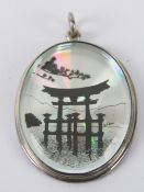 An unusual HM silver pendant having Japanese scene on silver background, hallmarked Sheffield, 5.