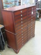 A contemporary chest of twelve drawers being two banks of double decked drawers,