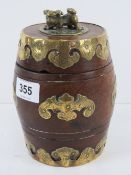 A delightful Oriental hardwood lidded barrel profusely decorated with gilt brass adornments and Fo