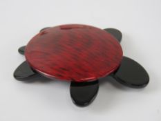 An overlaid plastic brooch in the style of Lea Stein in the form of a turtle, 7cm in length.