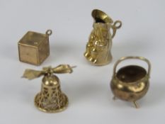 Four 9ct gold charms, each hallmarked 375, being dice, cauldron, toby jug and bell. 8.3g.