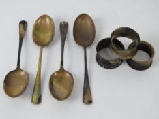 A quantity of HM silver table spoons and HM silver napkins rings having sustained fire damage.