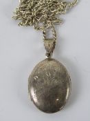 A silver locket having part floral engraving and stamped 925 on a HM silver chain,