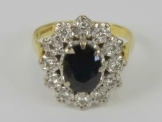 An 18ct gold sapphire and diamond cocktail ring, the central blue sapphire measuring 7.6 x 5.