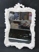 A contemporary mirror having white painted frame with acanthus leaf design, 55cm high overall.