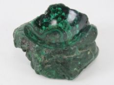 A solid piece of malachite carved and scalloped to form a pin dish, 9x 8cm.