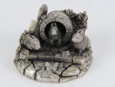 A HM silver Country Artists sculpture of three rabbits in a garden border, signed to back,
