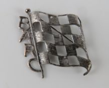 A silver BARC (British Automobile Racing Club) badge featuring 'chequered flag', stamped silver,