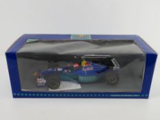 A 1997 Red Bull Sauber Petronas scale model racing car in box.