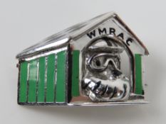An HM silver WMRAC brooch in the form of a dog within enamelled kennel with 'chequered flag' roof.