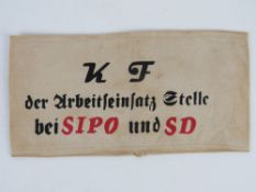 A WWII German KF arm band, in frame.