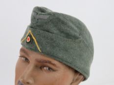 A WWII German Signals side cap.