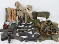 A quantity of militaria inc L12A1 Flare, MG34 leather sling, MG42 breach cover, SA80 magazine,